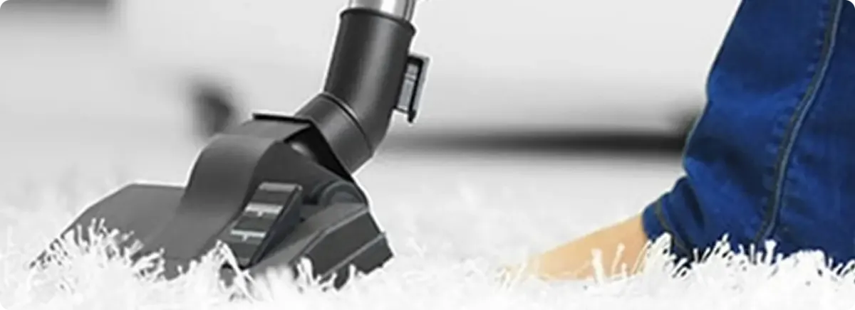 Close-up of a professional vacuuming a white carpet in Airway Heights.